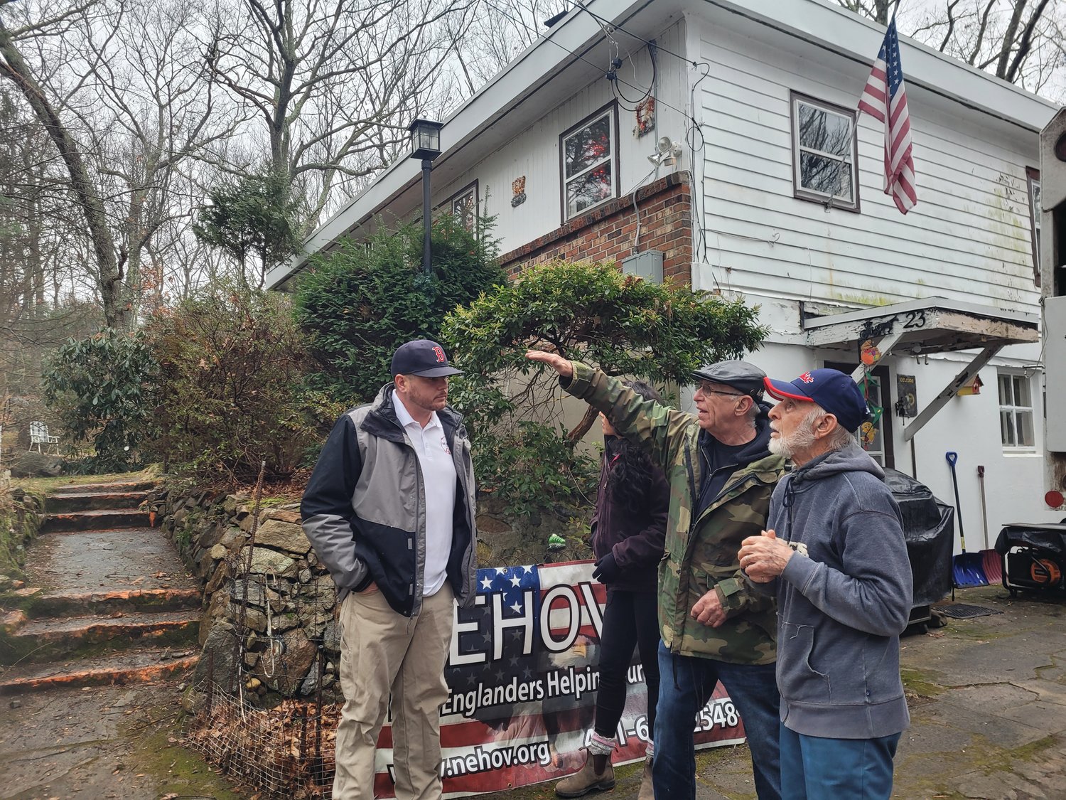 HOME REHABILITATED: New Englanders Helping Our Veterans President & Founder Jim Collins points out a few worrisome tree limbs to Korean War veteran Bernard “Bernie” Pavia at his Forest Drive home. A tree nearly totaled the house last Christmas. Collins, and N.E. Building & Restoration LLC Owner David Rosati, left, and Project Manager Chanya Sae-Eaw helped see the project through to the end.